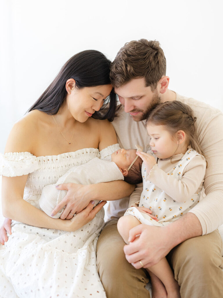 Family of four dressed in neutrals for Hampton Roads newborn photography session by Ashley Brickner 