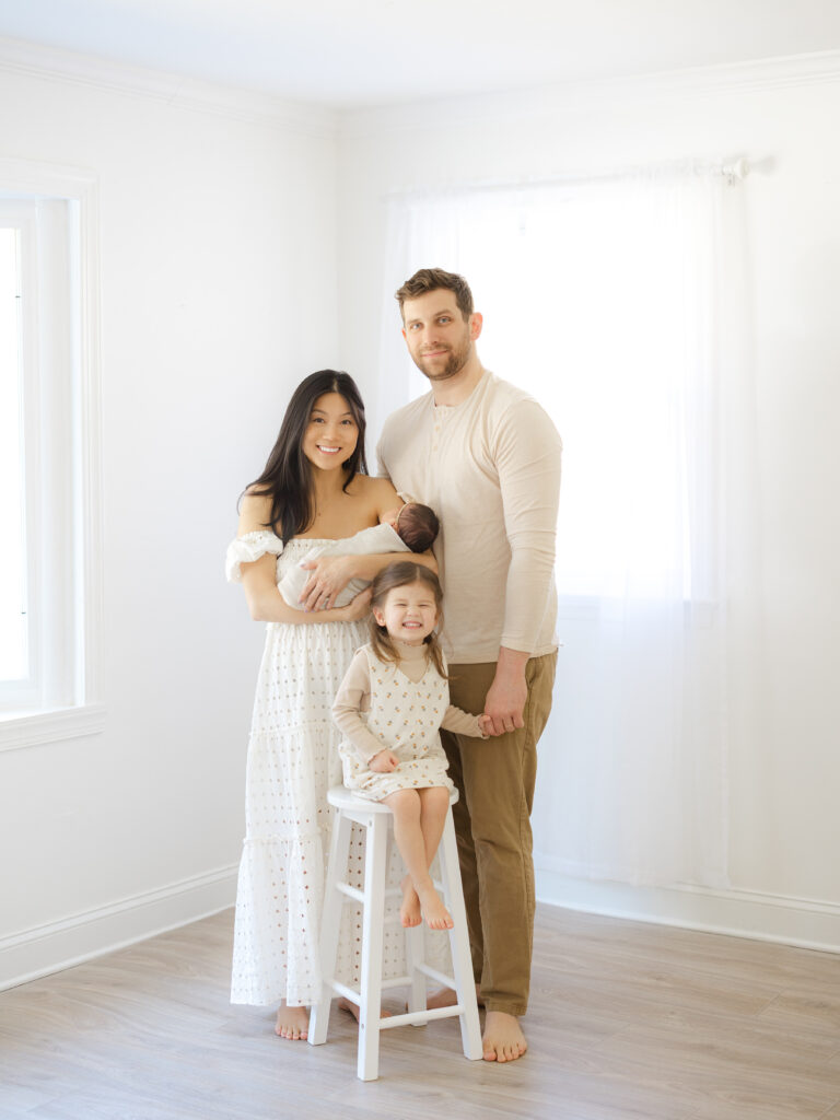 Family of four with newborn baby girl in studio by Virginia newborn photographer Ashley Brickner 