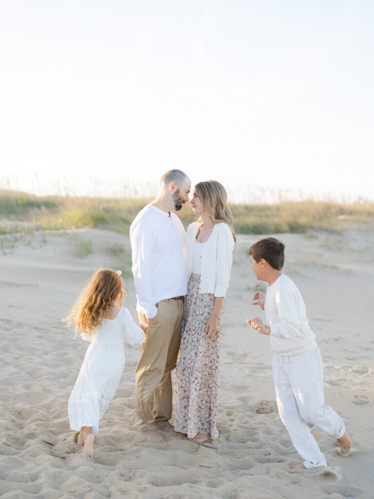 Family of four playing on beach by Virginia Beach mom and family photographer Ashley Brickner 