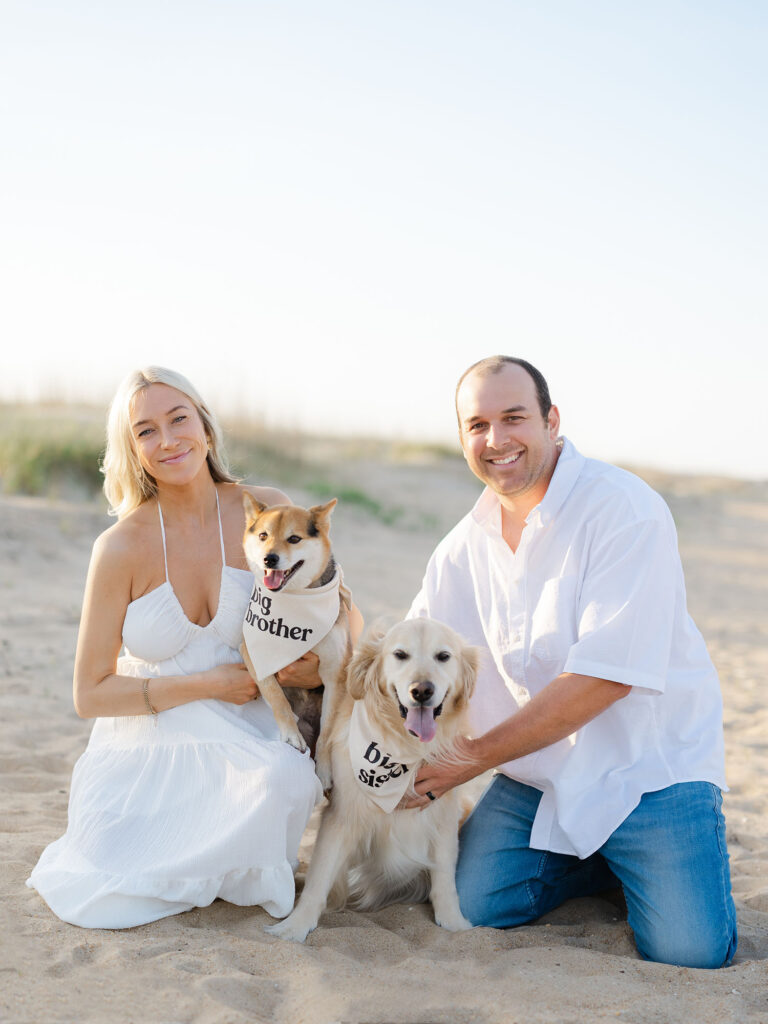 Women and man dressed in white holding dog in family photo by Virginia Beach family photographer Ashley Brickner 