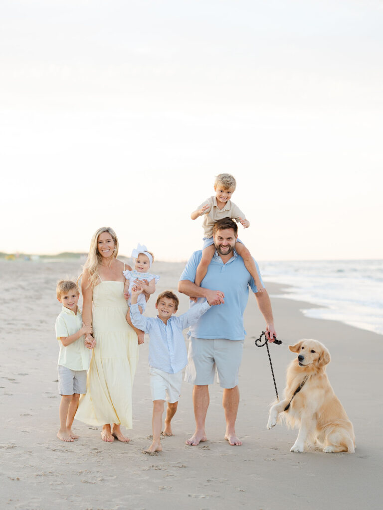 Family of six in blue and yellow with a dog in family photo in Virginia Beach by Ashley Brickner 