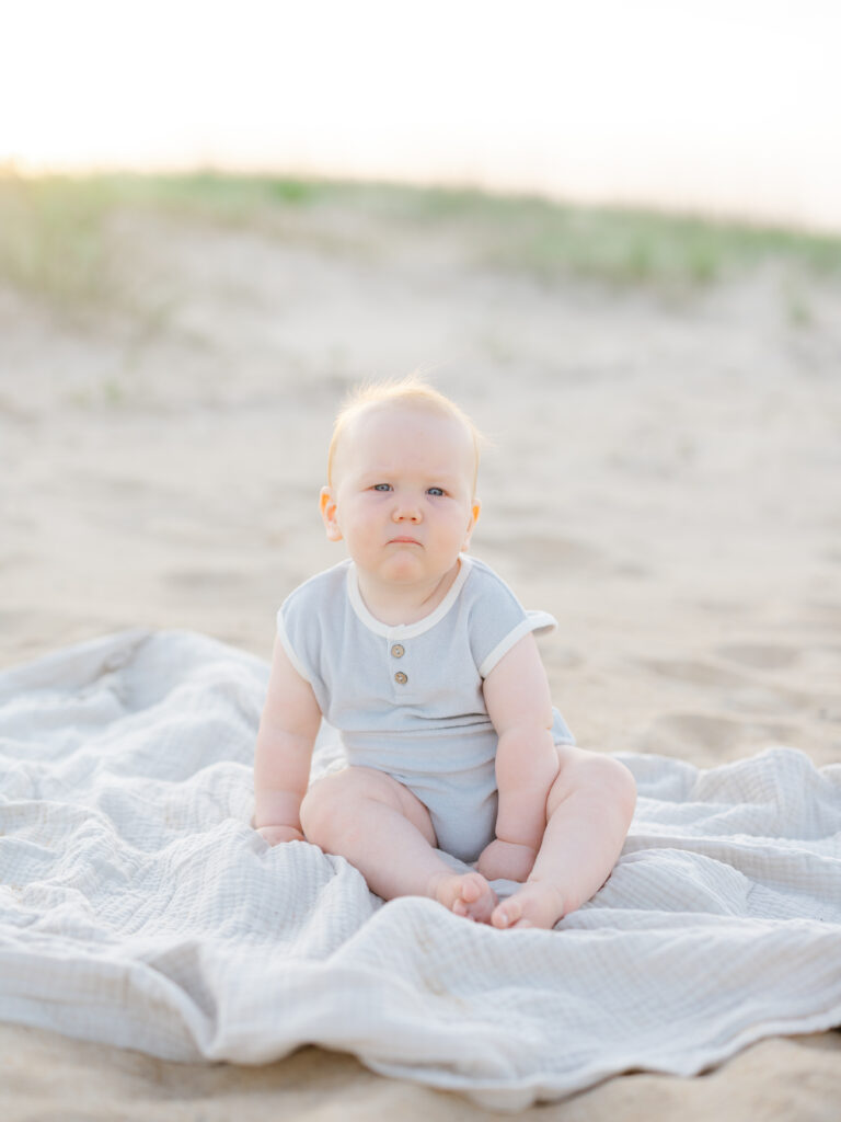 Baby boy sitting on blanket at the north end in Virginia Beach 
